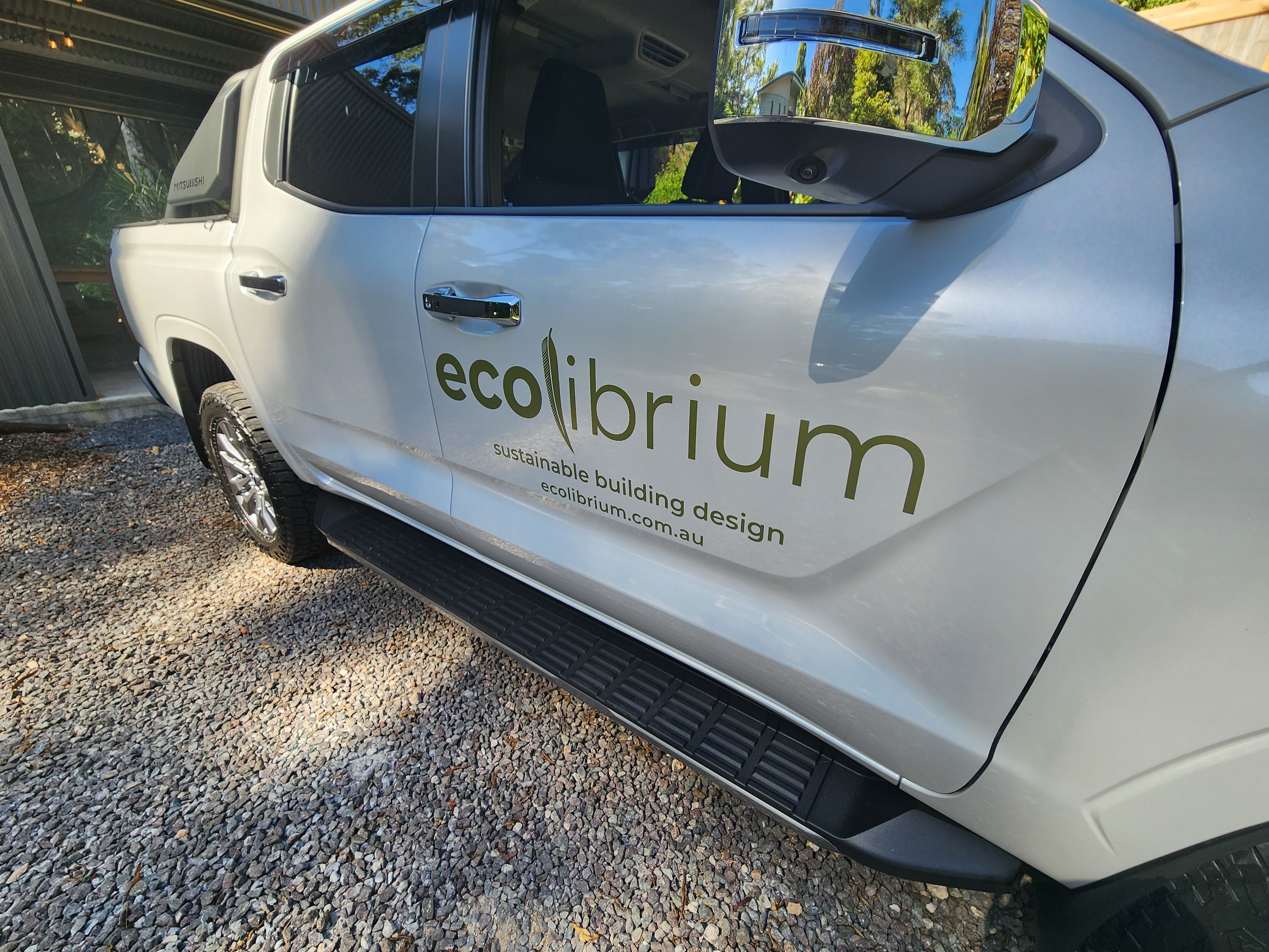 Custom coloured vinyl business graphics on a white work ute