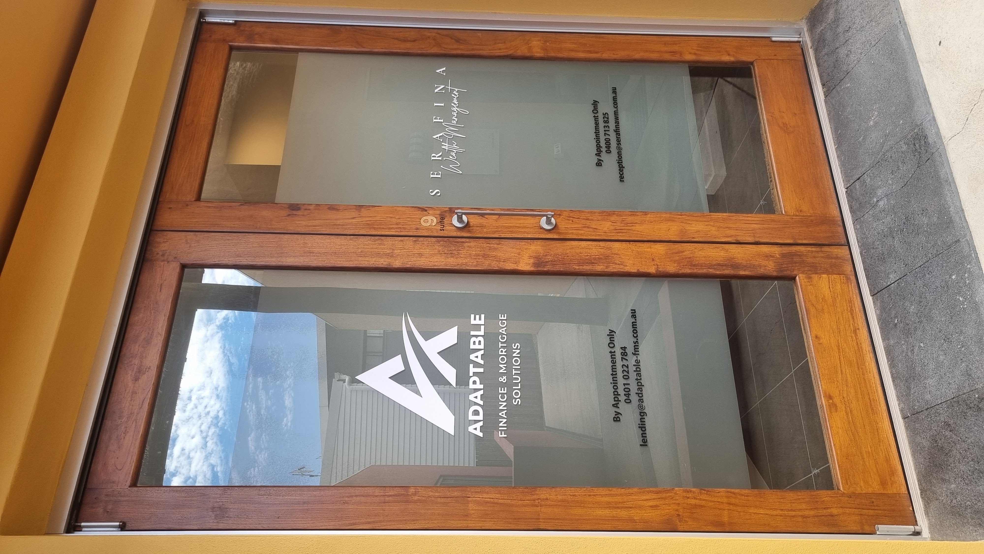 Frosted office door glazing with custom cut-out business graphics